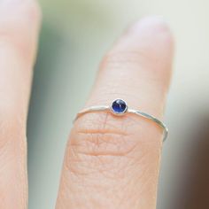 Tiny skinny stackable ring with beautiful deep blue Sapphire stone. It is made with a skinny but sturdy band, which allows you to create mind-blowing stacking sets! The ring is ideal for everyday wear and it will also look amazingly with a festive dress.The ring is 0,8-0,9 mm thick and looks very dainty on the finger. Choose the finish of the stone (smooth cabochon or rose cut) and material for the ring (sterling silver or 9k gold).If you want to change the ring band design or get a custom ring Adjustable Stackable Sterling Silver Birthstone Ring, Blue Gemstone Dainty Stackable Rings, Minimalist Sapphire Ring With Bezel Setting For Everyday, Everyday Stackable Sapphire Ring, Dainty Blue Gemstone Stackable Rings, Adjustable Stackable Birthstone Rings For Everyday, Everyday Adjustable Stackable Birthstone Ring, Adjustable Blue Birthstone Ring In Sterling Silver, Sterling Silver Everyday Birthstone Ring