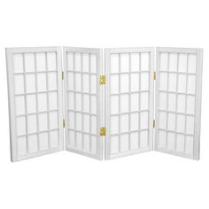 a white room divider with multiple panes and gold hardware on each panel,