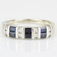 14k White Gold Sapphire Diamond & Anniversary Band Wedding Ring By Samuel Aaron This 14 Karat White Gold Ring Features 6 Baguette Sapphire Gemstones Measuring 3mm X 2mm Each, Complimented By 8 Round Diamonds Totaling .20 Carat. The Ring Is In Excellent Condition. This Ring Can Be Resized By Any Qualified Jeweler. Size: 7 Metal: 14 Karat White Gold Weight: 3.12dwt/ 4.84grams Gemstones: 6-Baguette Sapphires Diamonds: 8-Round .20 Carat Total I-2366 * Z-113 Elegant Sapphire Jewelry With Half Eternity Design, Elegant Sapphire Jewelry With Half Eternity, Modern Multi-stone Diamond Ring For Wedding, Formal Sapphire Diamond Ring With Half Eternity Setting, Formal Sapphire Diamond Ring With Half Eternity, Formal Sapphire Half Eternity Rings, Formal Diamond Sapphire Ring Channel Set, Formal Sapphire Ring With Channel Set Diamonds, Formal Channel Set Sapphire And Diamond Ring