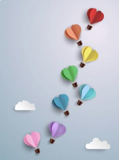 colorful hot air balloons floating in the sky with clouds and hearts cut out of them