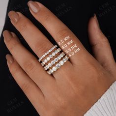 a woman's hand with three diamond rings on her left and two diamonds on the right