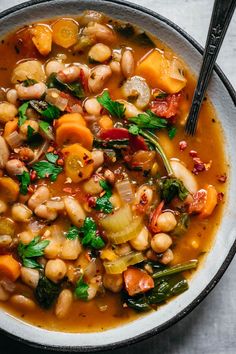 three bean vegetable soup in a bowl with spoons