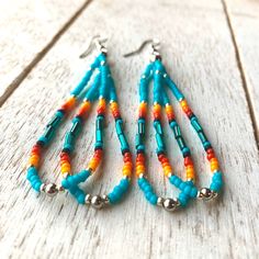 the beaded earrings are made with turquoise and orange beads