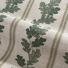 Oak Leaves and Stripes Design Length: Available by the meter or as a sample Width: 140 cm (54 inches) Composition: 90% Cotton, 10% Linen blend Design: Deep olive green background with beige-grey oak leaves and subtle stripe pattern Versatile Use: Ideal for curtains, blinds, cushions, and craft projects Continuous Cut: Orders over 1 meter are sent as a single continuous piece UK Shipping: Free delivery This elegant cotton-linen fabric features a beautiful oak leaf and stripe design on a deep olive green base it’s perfect for creating stylish home decor items like curtains, blinds, and cushions. Sold by the meter or as a sample, all orders over 1 meter are provided as a continuous piece. Enjoy free UK shipping on every order. Olive Green Fabric Texture, Leaf Wall Stencil, Green Upholstery Fabric, Shabby Chic Green, Buffalo Check Curtains, Upholstered Chairs Fabric, Olive Green Background, Cottage Curtains, Cushion Inspiration