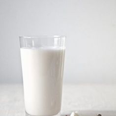 a glass of milk next to some cookies