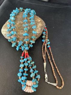 Gorgeous Native American Santo Domingo Blue Authentic Kingman Turquoise Nugget Beads, Shell Beads in a 2 Strand BEAD TREASURE Necklace. * This beautiful Treasure Necklace has 2 Strand Shell beads artistically strung with Shell and String * This Necklace goes well for casual dressed students or office goers. * Length 27" * Artisan Alfredo Aguilar ( Santo Domingo) . Made in USA * Free Gift Black Velvet Pouch with any purchase . Free Returns or Replacements within 30 Days of Purchase with tags intact.Please let us know the problem before posting a bad feedback.Fast, Free and Guaranteed ShippingFree Gift Pouch with Purchase (until Stocks last). Please contact seller for any questions and concerns. We hope you have a great experience with us and hope for an awesome review. Southwestern Turquoise Necklace For Beach, Traditional Blue Turquoise Necklace With Large Beads, Traditional Blue Jewelry For Beach, Traditional Blue Beach Jewelry, Traditional Turquoise Necklace For Beach, Southwestern Style Blue Beaded Necklace For Beach, Southwestern Style Blue Necklace For Beach, Traditional Blue Beads With Natural Stones, Southwestern Blue Beach Necklace