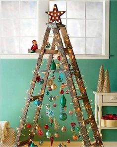 a christmas tree made out of wooden ladders with ornaments on top and lights around it