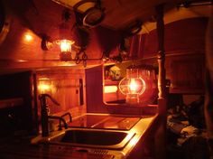 a kitchen area with sink, stove and lights