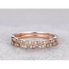 a rose gold wedding band with white diamonds on the top and bottom, set in 18k