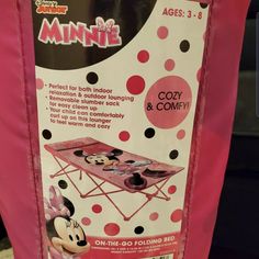 the back side of a pink minnie mouse folding table