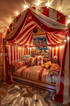 a circus themed bedroom with red and white striped walls, stars on the ceiling and curtains