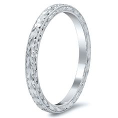 a white gold wedding ring with intricate details