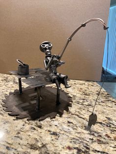 a metal figurine sitting on top of a table