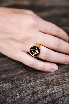 a woman's hand with a gold ring on it