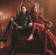 a man and woman sitting on top of a throne