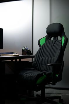 an office chair sitting in front of a desk with a monitor and keyboard on it