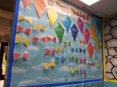 colorful kites hanging from the side of a birthday card board with writing on it