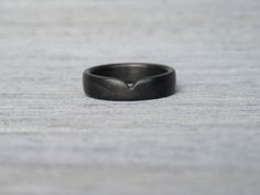 a black ring sitting on top of a wooden table