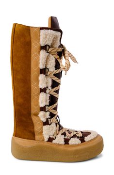 Shearling accents amplify the wintry vibes of a comfortable boot that's sure to be a street-style star. 1" heel 16" shaft; 13" calf circumference. Narrow calf Lace-up style Leather and genuine shearling (India) upper/leather lining/rubber sole Imported Winter Shearling Boots With Lug Sole, Luxury Winter Boots With Lug Sole, Winter Boots With Suede Lining And Shearling Material, Luxury Brown Shearling Boots, Luxury Winter Boots With Faux Fur Trim, Brown Sheepskin Boots With Faux Fur Lining, Luxury Leather Boots With Faux Fur Lining, Mukluk Boots, Flat Platform Sandals