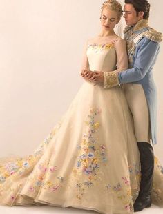 a man and woman are dressed up in wedding gowns, standing next to each other