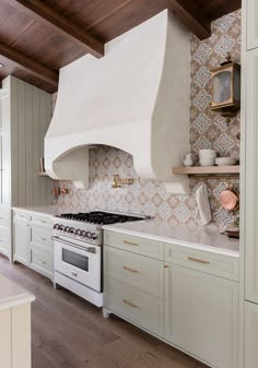 a white stove top oven sitting inside of a kitchen