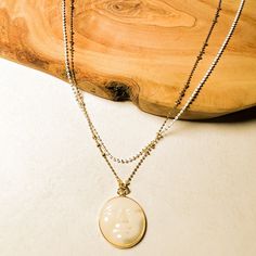 The full moon is both enchanting and sparks our imagination and creativity with its bright glow. Here, a carved amulet with Mother of Pearl showcases a serene face of the full moon. We've combined this with 2 layers of our faceted chain that gives the most beautiful sparkle like twinkling stars. The back of the necklace has a 2 inch extension to allow flexibility in the length. ⬩20mm Round Moon shape⬩18 inch Plated Double Chain necklace⬩Mother of Pearl is said to provide soothing protection from Gold Moon-shaped Tarnish-resistant Necklace, Moon-shaped Necklace With Large Pendant For Gift, Elegant Moon-shaped Necklace With Pearl Pendant, Mother Moon, Bohemian Moon-shaped Gemstone Necklace, Silver Moon-shaped Necklaces For Meditation, Mother Necklace, Double Chain Necklace, Twinkling Stars