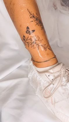 a woman's leg with tattoos on it