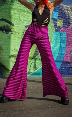 The Pink & Black Stripe Big Bells are your go-to stylish everyday pant. Dress these flattering pants up or down- truly perfect for almost any occasion. Design Features: High waistband hits comfortably at your true waist Waistband can be rolled down to expose belly Perfectly hugs hips Pant leg flares into large bells Fantastic garment to dress up and down. Incredibly vibrant print. Made in San Francisco, CA, USA Fabric Features: Radical vertical Pink and Black stripe. Moisture Wik Polyester/Spand High Waist Yoga Pants With 4-way Stretch For Spring, Trendy Elastic Full-length Bottoms, Chic Stretch Yoga Pants With Elastic Waistband, Versatile Elastic Bottoms For Spring, Elastic Bottoms For Night Out, Versatile High Waist Yoga Pants For Summer, Versatile Stretch Harem Pants For Spring, Trendy Spring Yoga Pants With Elastic Waistband, Fitted Yoga Pants With Elastic Waistband For Summer