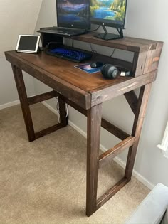 two computer monitors sitting on top of a wooden desk