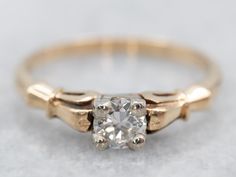 This vintage engagement ring is sweet and feminine, while still being easy to wear every day. The stone is encased in a square, white gold head. This protects the diamond and also allows some light into the bottom to shine up through the stone. Simply adorned yellow gold shoulders provide a wonderful balance to the geometric, Illusion style head!Metal: 14K Yellow and White GoldGem: Diamond .24 Carats, VVS2 in Clarity, H in ColorGem Measurements: 4.0 mm, roundRing Size: 5.75Marks: "14K" Stamped on the inside band Retro Engagement Ring, Geometric Illusion, Geometric Engagement Ring, Gold Engagement Ring Diamond, Retro Engagement Rings, Bezel Engagement Ring, Retro Era, Gold Diamond Engagement Rings, Diamond Solitaire Ring