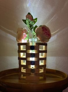 a vase filled with flowers sitting on top of a wooden table