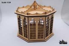 a wooden model of a building with windows