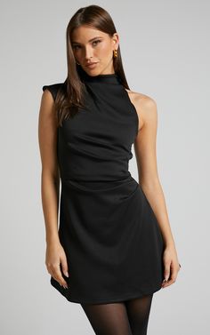 Get ready to turn heads at your next party night with the Rubie Mini Dress. This trendy one shoulder dress features a high neck and an asymmetrical hemline, giving it a unique and fashion-forward look. Made from ponte fabric, this A line dress hugs your curves in all the right places while providing comfort throughout the night. The black color adds a touch of sophistication, making it perfect for any occasion. Made from polyester, this mini dress is not only stylish but also easy to care for. P Black High Neck Dress Short, Short Black Dress Elegant, Cute Cocktail Dresses Classy, High Neck Mini Dress Formal, Black Dress Colorful Accessories, Black Dress Outfit Party Night Classy Winter, High Neck Cocktail Dress, High Neck Dress Jewelry, Classy Christmas Dress