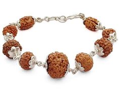 This is a Powerful and unique Rudraksha Navagraha Bracelet. The Navgrah Rudraksha Beads Bracelet consists of Rudraksha from 2 Mukhi to 9 mukhi and 12 Mukhi (1 Bead each). This Bracelet appeases all the negative planets and gives power to benefic planets. Navgarh Rudraksha Bracelet should definitely be worn by everyone. This is a Powerful and unique Rudraksha Navagraha Bracelet. The Navgrah Rudraksha Beads Bracelet consists of Rudraksha from 2 Mukhi to 9 mukhi and 12 Mukhi (1 Bead each). This Bracelet appeases all the negative planets and gives power to benefic planets. Navgarh Rudraksha Bracelet should definitely be worn by everyone. Navgrah Mala Rudraksha Beads do not have any negative effect. It would definitely give you benefits. Wearer of Navgrah Rudraksha Mala - Rosary is blessed with Traditional Silver Beaded Bracelets For Festivals, Traditional 8mm Beaded Bracelet, Traditional 8mm Bead Bracelet Jewelry, Traditional 8mm Bead Bracelet, Gemstone Beaded Bracelets For Festivals And Gifts, Traditional Brown Beaded Bracelets For Rituals, Traditional Silver Beaded Bracelets With Gemstone Beads, Fusion Style Bracelets For Rituals And Festivals, Traditional Rosary Bracelet With 8mm Beads As Gift