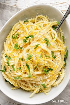 a white bowl filled with pasta and parmesan cheese