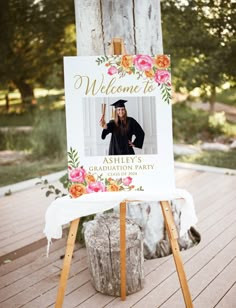 an easel with a sign that says welcome to asley's graduation party