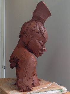 a chocolate sculpture sitting on top of a wooden table