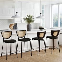 four chairs are lined up in front of the kitchen counter and island with a potted plant on it