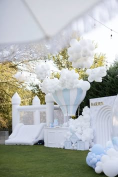 balloons are floating in the air over an outdoor area