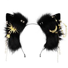 a pair of black furry ears with gold stars and moon decorations