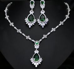 Not sold in Stores! Who doesn't love to dress up in their finest and flirt their style? This is perfect for an evening soiree, wedding, or party night. You'll come up with an occasion for sure! This Luxe Cubic Zirconia Necklace Earring Set - comes in a variety of simulated stones: Emerald Green/ Sapphire Blue or Wizard White. Make your evening cocktail dress or ball gown stand out even more. We know you'll wear it so well! Included Additional Item Description: * 1 pair Drop Earrings in your choice of 3 beautiful colors * 1 pc Necklace in your choice of 3 beautiful colors Earrings Length: 5.6 cm or 2-1/4" in. approx. Empress Drop Earrings Matching Choker Necklace: 43 cm or 17" in approx. Shop with confidence with our secure checkout: Apple Pay-Mastercard-Visa & PayPal FREE SHIPPING! Please Glamorous Bridal Earrings With Elegant Design, Glamorous Formal Bridal Earrings With Elegant Design, Glamorous Elegant Bridal Earrings For Formal Occasions, Glamorous Formal Jewelry Sets, Elegant Jewelry Sets With Jewels For Party, Glamorous Formal Bridal Earrings Hand Set, Glamorous Formal Bridal Earrings With Diamond Accents, Glamorous Hand Set Bridal Earrings For Formal Occasion, Glamorous Bridal Earrings Hand Set For Formal Occasions