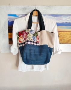 a handbag hanging on a wall next to a painting