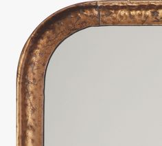 an old mirror with gold paint on it