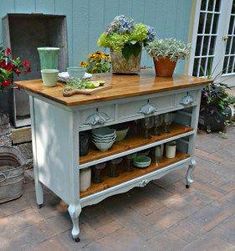 a kitchen island with pots and pans on it in front of a blue building