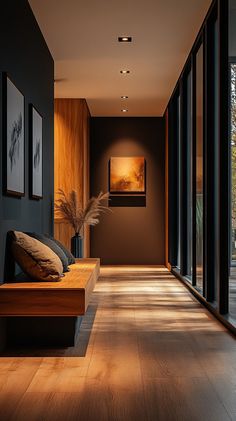 an empty hallway with wood flooring and large glass doors leading to the outside area