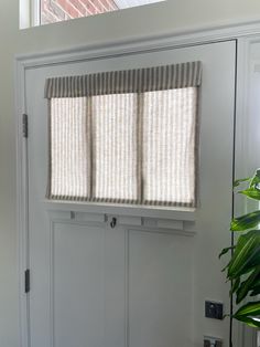 We are proud to say this product is custom made in the USA; made with care, using a high-quality, hand-picked fabric.   Enjoy convenience and style with our Small Front Door or Sidelight Curtains. Designed for ease of use, simply fold or roll up in seconds. These curtains are more than just entryway coverings; they elevate your space. With no cords or holes, installation is a breeze, requiring only our provided Adhesive Hook & Loop Fastener strip, eliminating the need for hardware, putting no holes in your door. Fabric Description and Content: This Taupe Striped Fabric is a medium weight and very soft. The background color is a beige, creamy oatmeal color and the stripe is a grayish tan color. This fabric allows a lot of light through, but still gives full privacy, even at night. Made from Front Door Window Valance, Door Small Window Treatments, Fabric Door Covers, Front Door Roll Up Shade, Mobile Home Door Window Curtain, Front Door Side Window Blinds, Laundry Door Curtain, Mini Blinds For Front Door, Small Patio Door Coverings