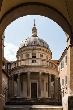 an old building with a cross on top and steps leading up to the entrance way