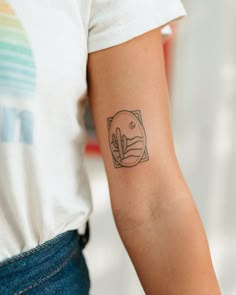 a person with a small tattoo on their arm