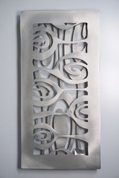 an abstract metal artwork on the wall