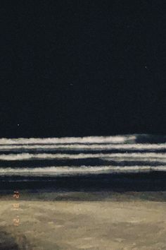 an airplane is flying over the ocean at night